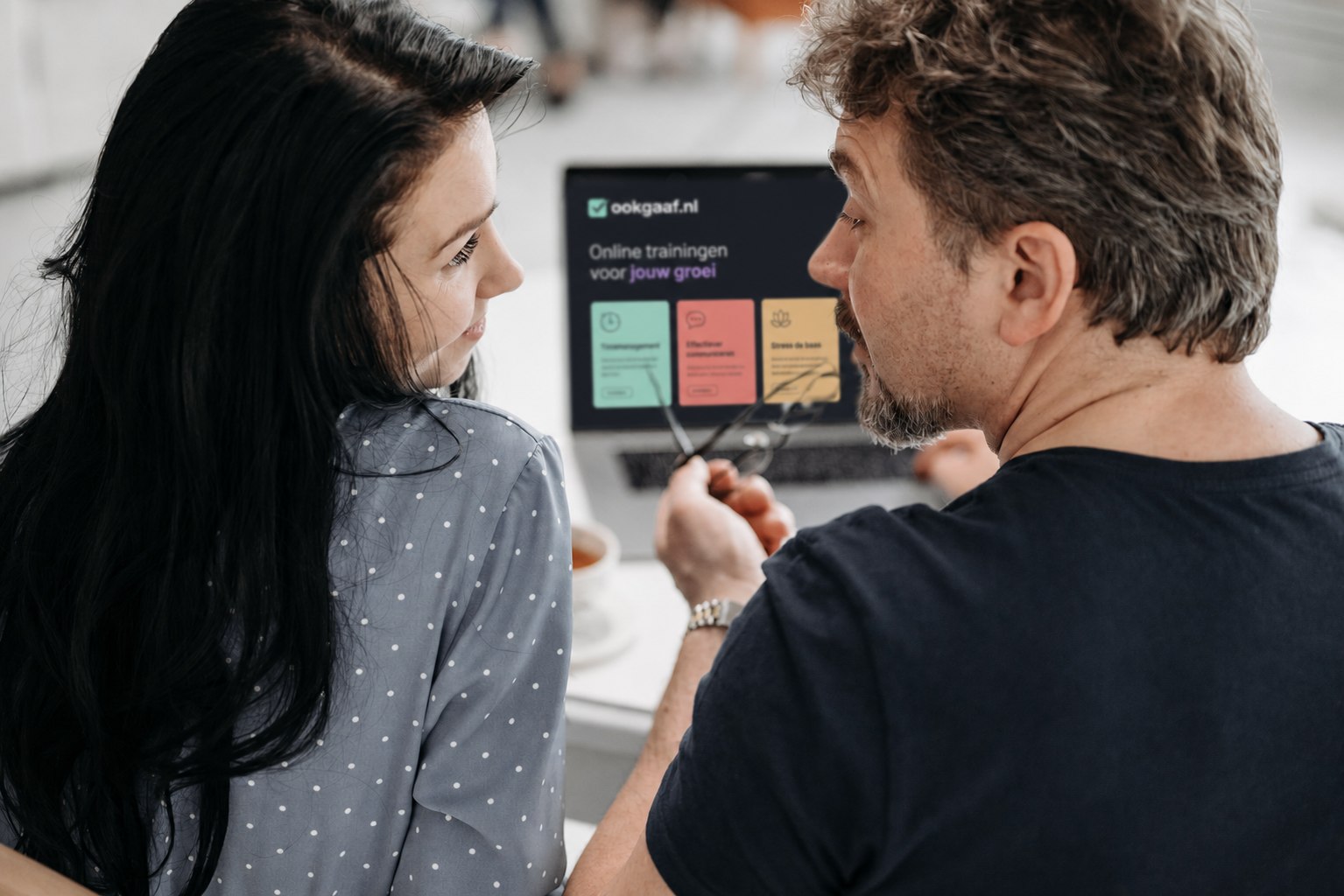 Twee mensen bekijken samen Ookgaaf op een laptop